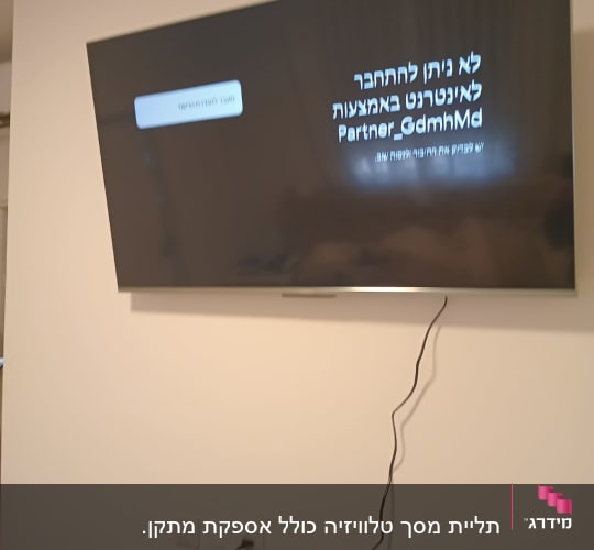 טלוויזיה תלויה על הקיר עם כבל חשמל מחובר
